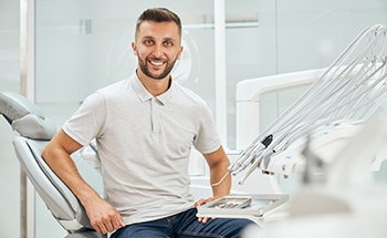 Male dental patient sitting up and smiling