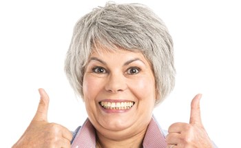 older woman giving thumbs up