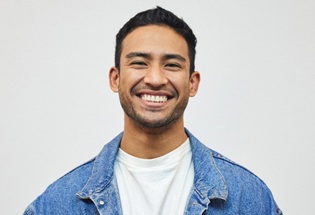 smiling person wearing a jean jacket