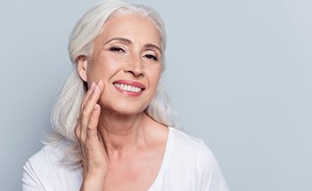 Older woman with implant-retained dentures.