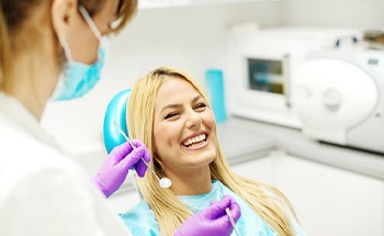 Woman laughing in dental chair at United Concordia dentist