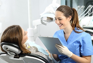 woman smiling while talking to cosmetic dentist in San Antonio 
