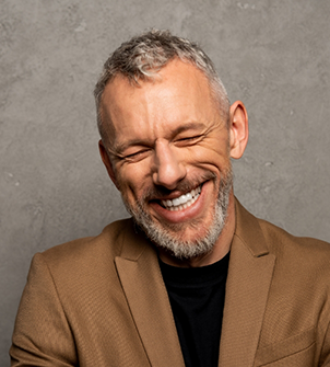 Smiling man in a brown dinner jacket