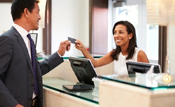 A receptionist taking a credit card
