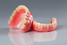 Dentures resting on a reflective surface