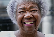 Woman with dentures smiling brightly