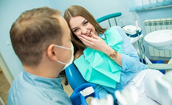 young woman smiling at dentist in San Antonio 