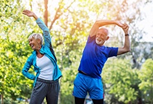 couple in a park stretching before exercising 