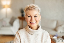 Woman with short hair and turtle neck smiling