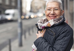 elderly person wearing a coat and scarf 