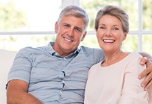 elderly couple sitting on a couch 