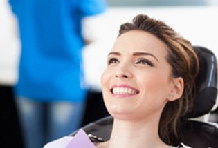 Closeup of woman smiling in dentist's treatment chair 