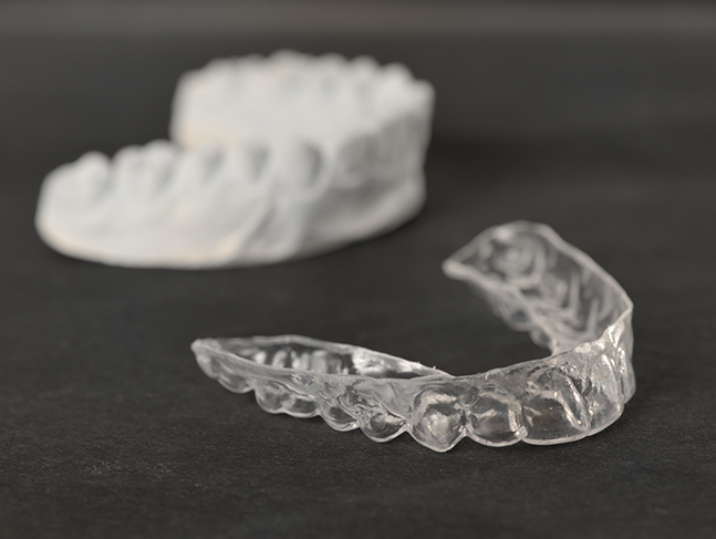 Invisalign clear aligner on a flat surface