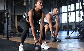 Woman lifting weights in workout class