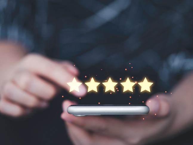 Person writing a five star review on their phone