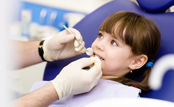 Young girl receiving dental treatment