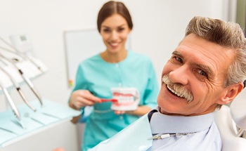 Senior man smiling in dental chair