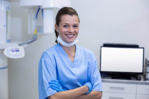 Dentist in scrubs showing dental practice safety.