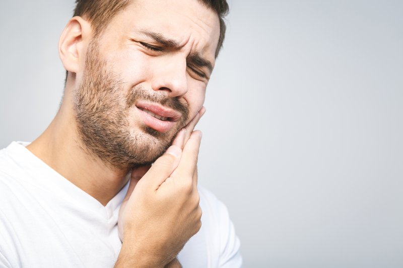 Man experiencing dental emergency