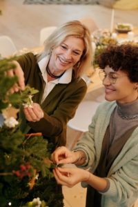 Woman with dental implants decorating tree