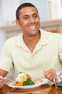 man eating baked potato